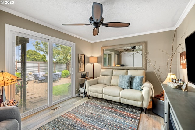 440 S Cascade Dr, Woodburn, OR 97071 - living area with ceiling fan, light wood-type flooring, a textured ceiling, and crown molding
