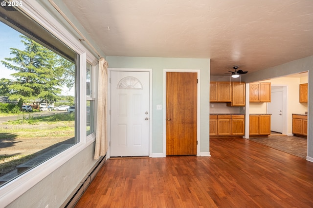 3198 Pheasant Blvd, Springfield, OR 97477 - kitchen featuring dark wood-style flooring, a baseboard radiator, and a ceiling fan