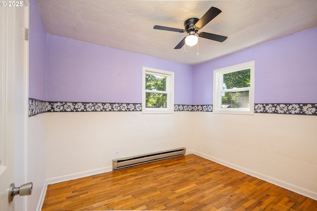 3198 Pheasant Blvd, Springfield, OR 97477 - unfurnished room featuring a baseboard radiator, wood finished floors, and ceiling fan