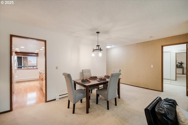 dining area with light colored carpet, baseboard heating, and a notable chandelier