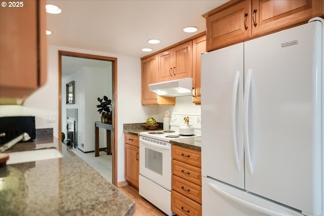 kitchen with under cabinet range hood, a sink, recessed lighting, white appliances, and light stone countertops