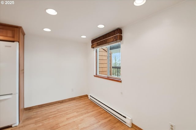unfurnished room with recessed lighting, light wood-style flooring, baseboards, and a baseboard radiator