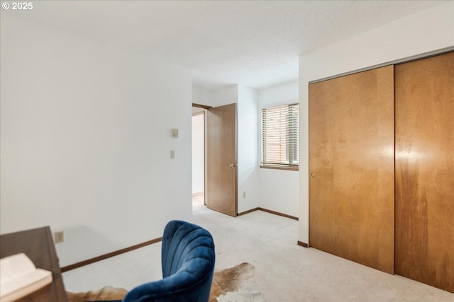 interior space with baseboards and light colored carpet