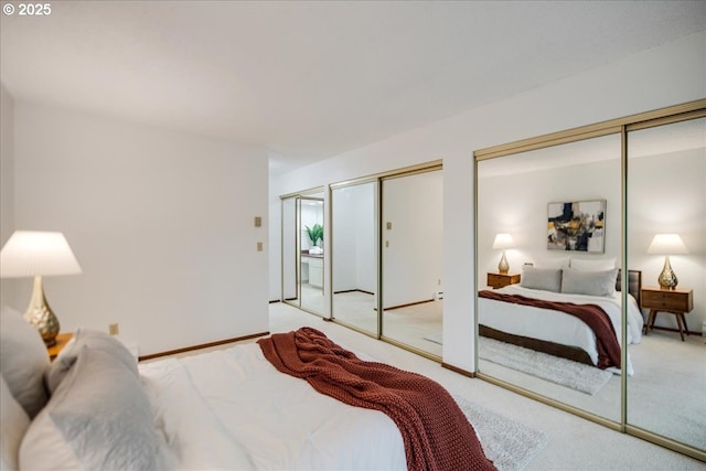 carpeted bedroom with multiple closets