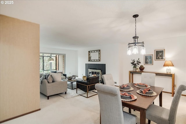 dining area featuring light colored carpet and a tile fireplace