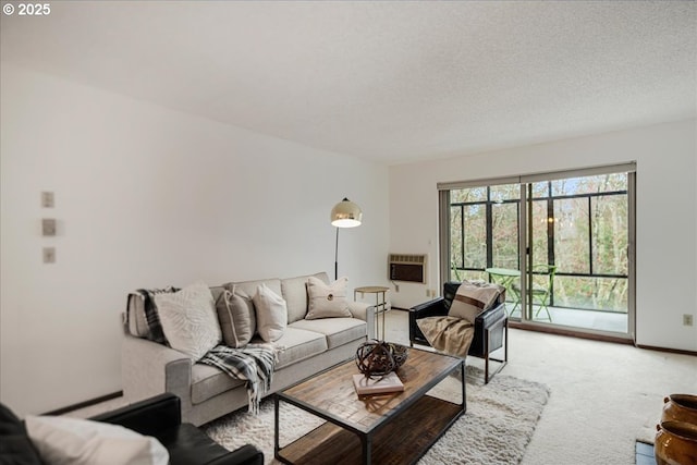 living area with light colored carpet, baseboards, and a textured ceiling
