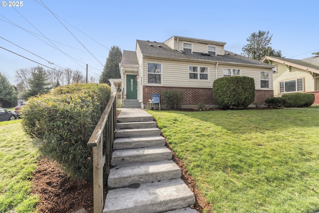 bungalow featuring a front lawn and brick siding