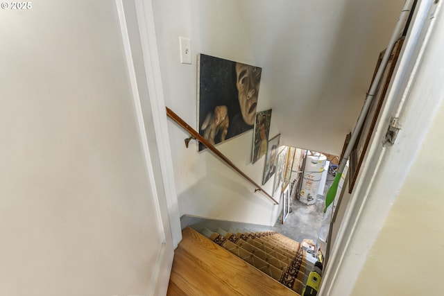 stairway with concrete floors and water heater