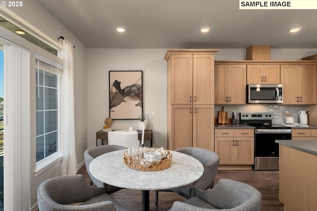 kitchen with stainless steel appliances, dark hardwood / wood-style flooring, tasteful backsplash, and light brown cabinetry