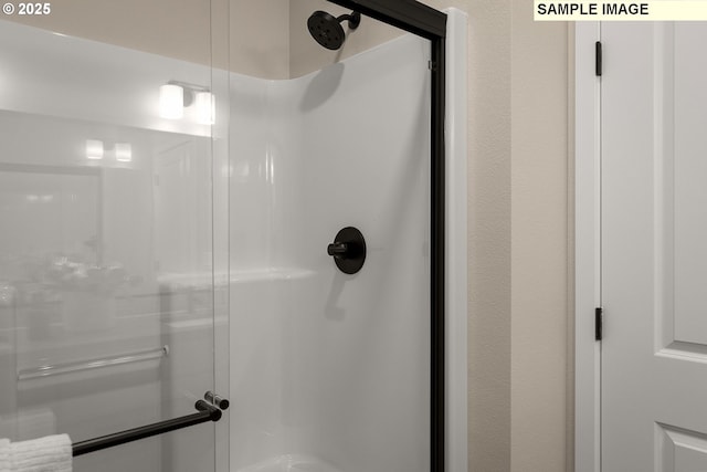 bathroom with a shower with shower door