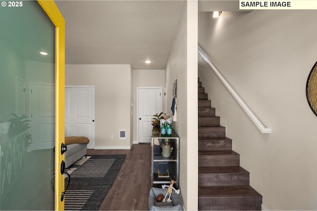 staircase with hardwood / wood-style floors