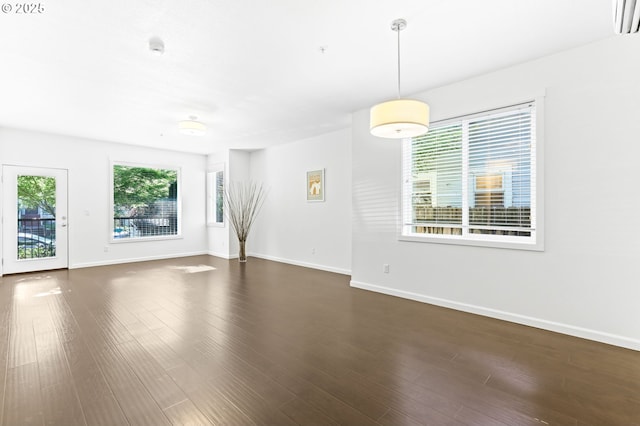 3963 N Montana Ave Unit 1, Portland, OR 97227 - empty room featuring healthy amount of natural light, dark wood finished floors, and baseboards