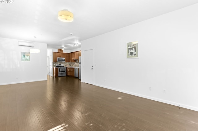 3963 N Montana Ave Unit 1, Portland, OR 97227 - unfurnished living room featuring dark wood-type flooring, baseboards, and a wall mounted AC
