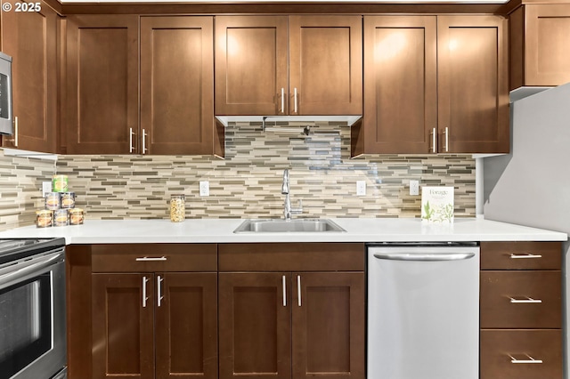 3963 N Montana Ave Unit 1, Portland, OR 97227 - kitchen with appliances with stainless steel finishes, a sink, light countertops, and backsplash