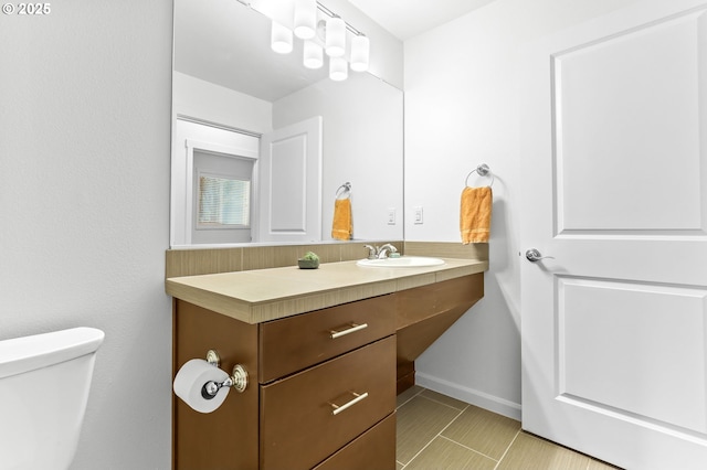 3963 N Montana Ave Unit 1, Portland, OR 97227 - half bath with toilet, vanity, tile patterned flooring, and baseboards
