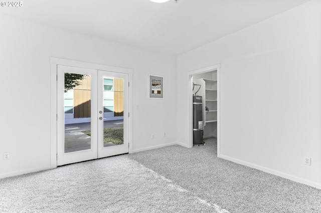 3963 N Montana Ave Unit 1, Portland, OR 97227 - carpeted spare room with water heater, french doors, and baseboards