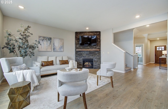 living room with a fireplace and light hardwood / wood-style floors