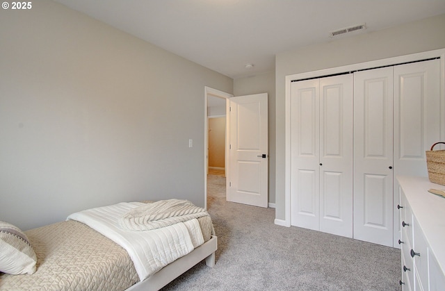 bedroom with light carpet and a closet