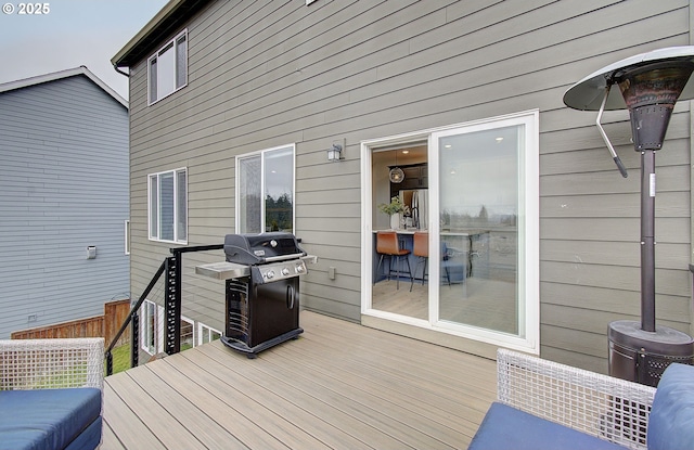 wooden deck featuring area for grilling