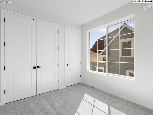 unfurnished bedroom featuring light carpet and a closet