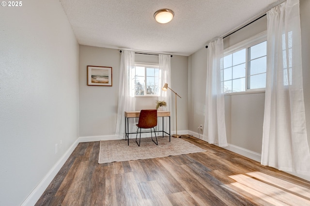 office with hardwood / wood-style floors and a textured ceiling