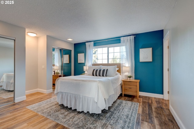 bedroom with hardwood / wood-style floors and a textured ceiling