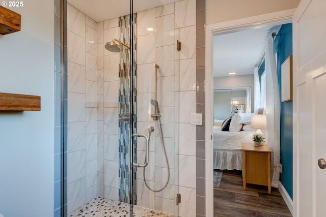 bathroom with walk in shower and wood-type flooring