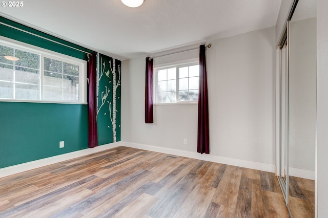 unfurnished room featuring hardwood / wood-style flooring