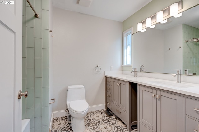 bathroom with tile patterned flooring, vanity, walk in shower, and toilet