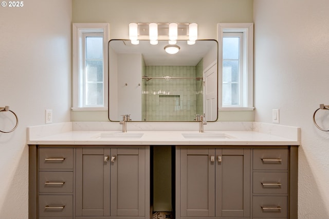 bathroom featuring vanity and an enclosed shower