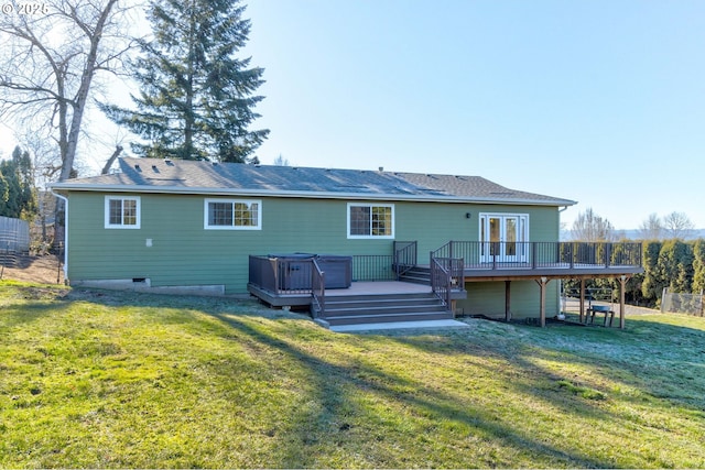 back of property with a wooden deck, a yard, and french doors