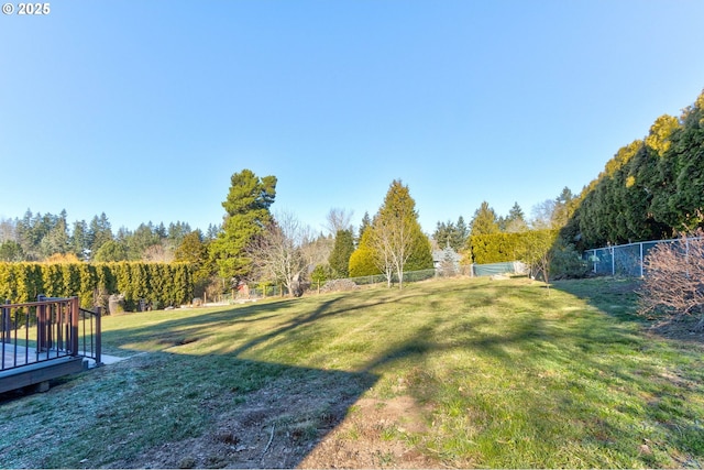 view of yard with a wooden deck and a rural view