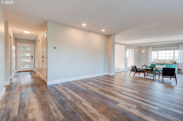 interior space featuring hardwood / wood-style flooring and a textured ceiling