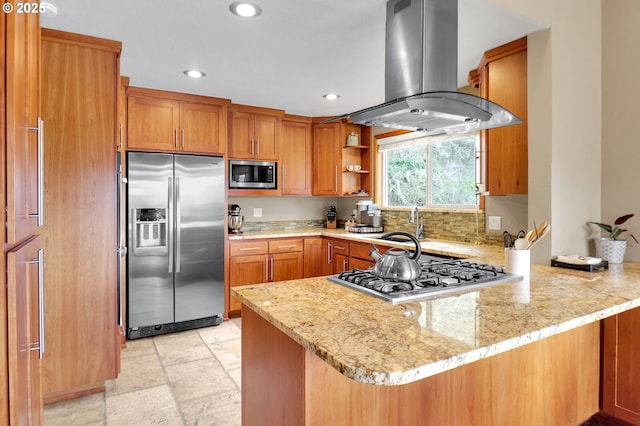 kitchen with appliances with stainless steel finishes, island exhaust hood, a peninsula, recessed lighting, and light stone countertops