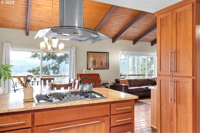 kitchen featuring stainless steel gas stovetop, wood ceiling, exhaust hood, brown cabinetry, and a chandelier