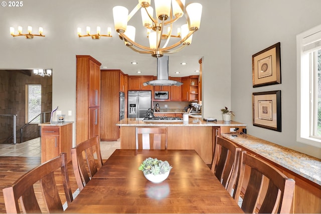 dining space with healthy amount of natural light, a chandelier, and recessed lighting