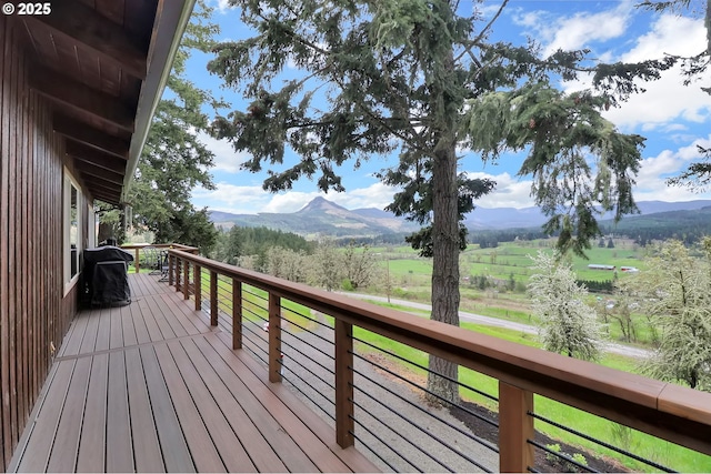 wooden deck with a mountain view and a view of countryside