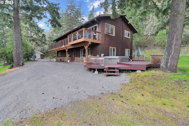 rear view of property featuring a deck