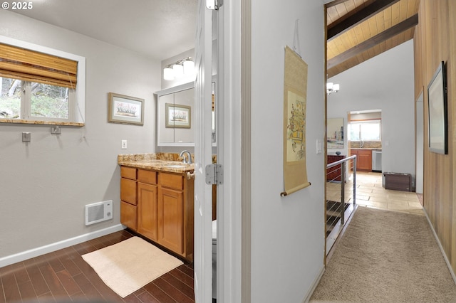bathroom with baseboards, vanity, wood finished floors, and wood ceiling