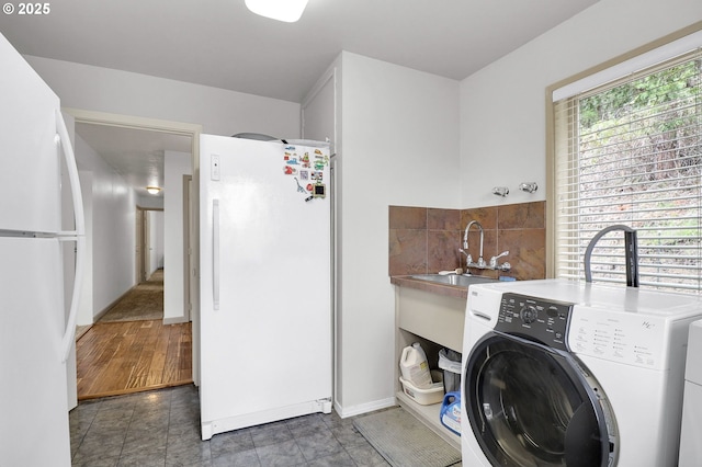 washroom with washer / dryer and baseboards