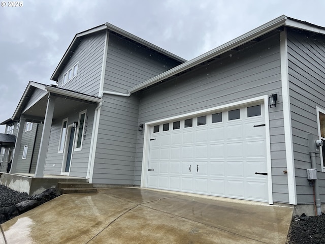 1028 Forest Heights St, Sutherlin, OR 97479 - view of home's exterior featuring concrete driveway, a porch, and a garage