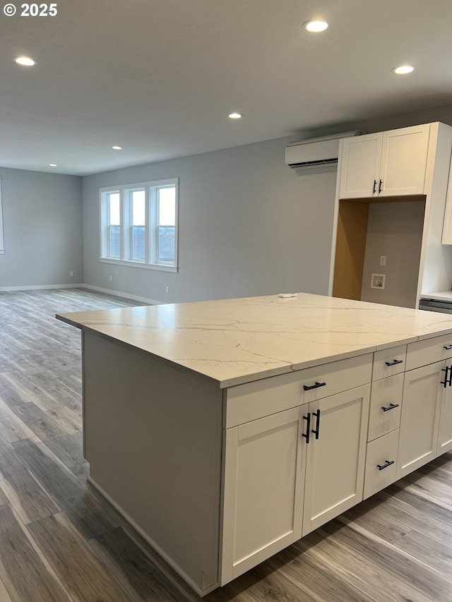 1028 Forest Heights St, Sutherlin, OR 97479 - kitchen with a wall mounted air conditioner, white cabinetry, recessed lighting, and dark wood-style floors