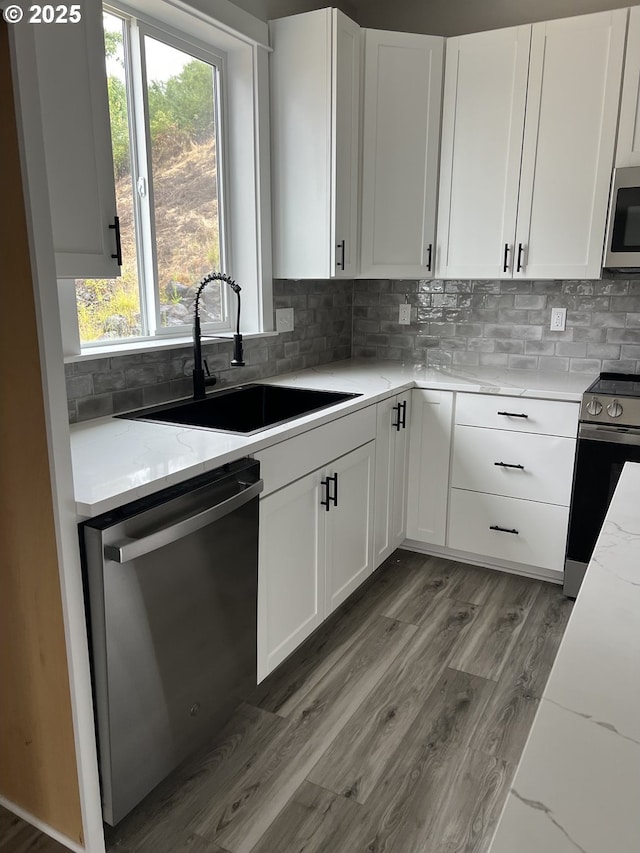 1028 Forest Heights St, Sutherlin, OR 97479 - kitchen featuring appliances with stainless steel finishes, light stone counters, and white cabinets