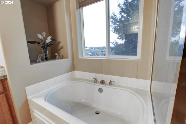 bathroom with vanity and a tub