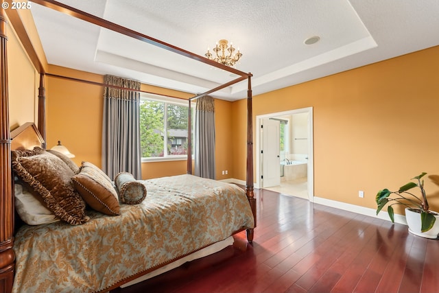 3356 NW 153rd Ter, Portland, OR 97229 - bedroom featuring a tray ceiling, wood finished floors, connected bathroom, and a textured ceiling