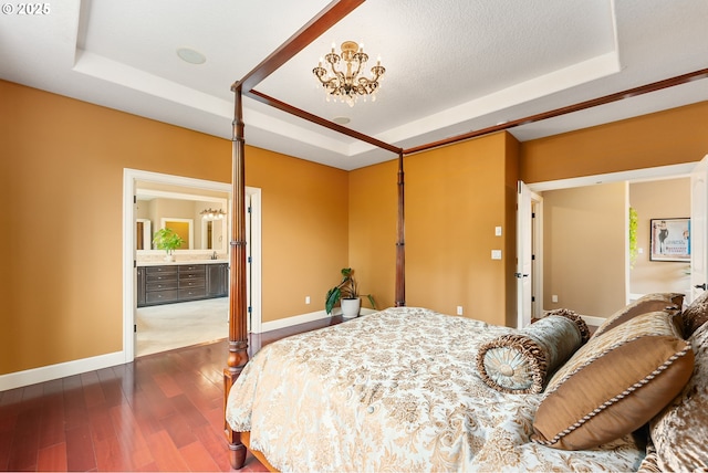 3356 NW 153rd Ter, Portland, OR 97229 - bedroom featuring a tray ceiling, dark wood-style floors, ensuite bath, and a chandelier