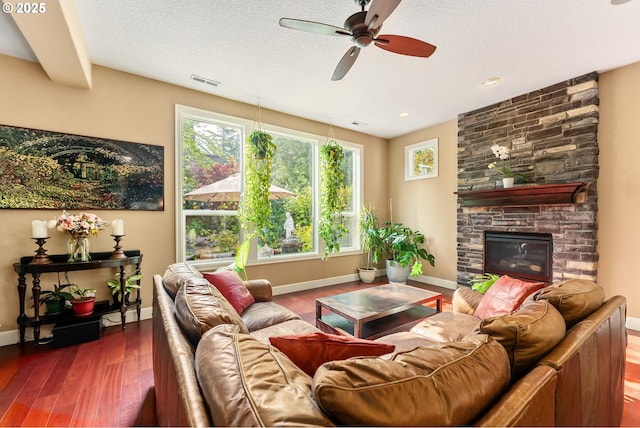 3356 NW 153rd Ter, Portland, OR 97229 - living area featuring ceiling fan, wood finished floors, a fireplace, and a textured ceiling