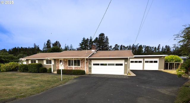 745 N 8th St, Lakeside, OR 97449 - single story home with an attached garage, asphalt driveway, a front yard, a chimney, and brick siding