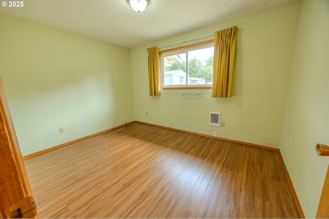 745 N 8th St, Lakeside, OR 97449 - empty room with wood finished floors, baseboards, and heating unit