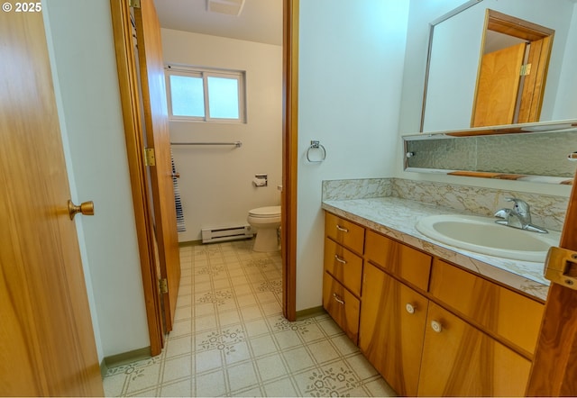 745 N 8th St, Lakeside, OR 97449 - bathroom featuring baseboard heating, vanity, toilet, tile patterned floors, and baseboards